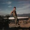 Bill Van Guilder"THEN" at Fire Base 6 in Dakto , Jan. 20th 1969 sitting atop a 155 Howitzer 